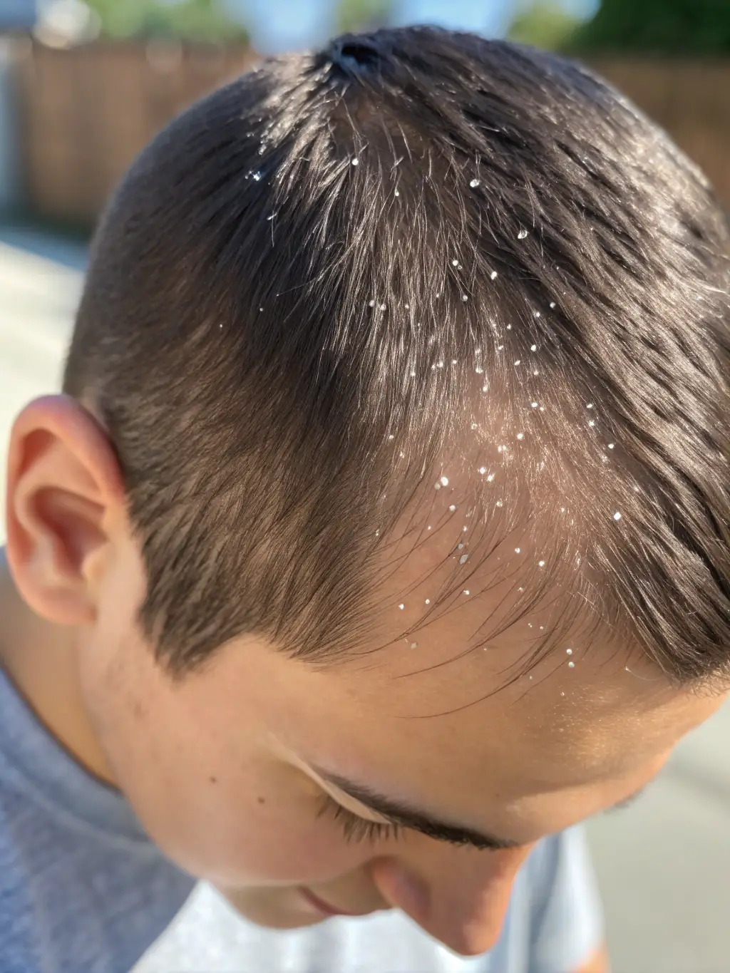 A close-up image of a client's scalp receiving a hydrating treatment, emphasizing the nourishment and care provided.